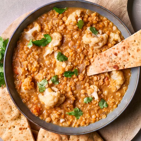 Rode linzenstoof met bloemkool en naan