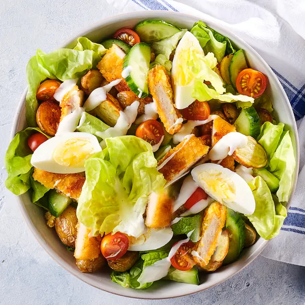 Caesarsalade met kipschnitzel en ei