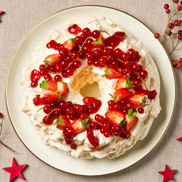 Kerstpavlova met aardbeien en rode bessen